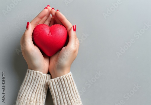 Person Holding Red Heart in Hands