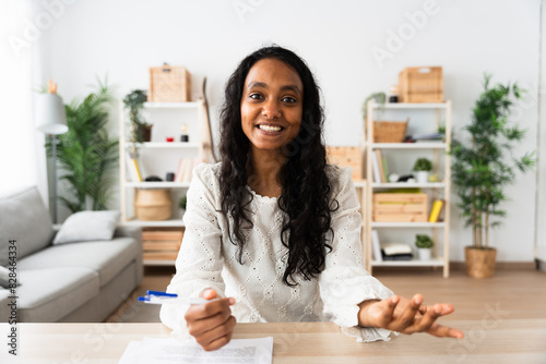 Young Indian woman talking to camera at home. Webcam view of student having video call.