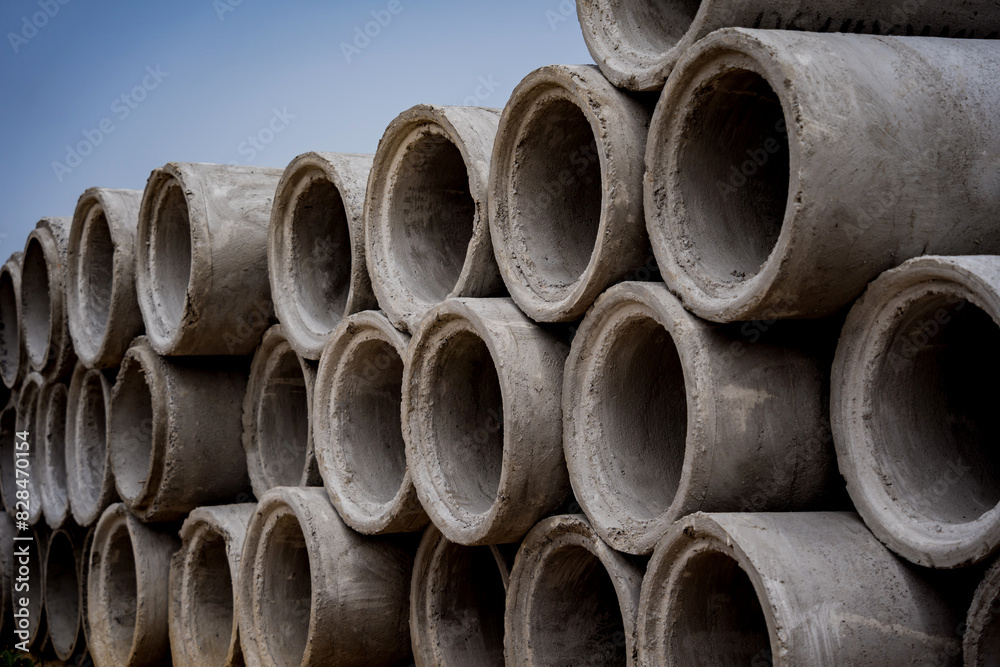 A stack of concrete ring pipes piled and creating a symmetrical arrangement A stack of concrete ring pipes piled and creating a symmetrical arrangement