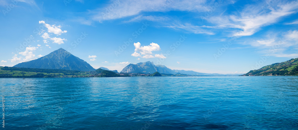 lake Thunersee and Niesen mountain, view from boat trip, blue sky with clouds. switzerland lake Thunersee and Niesen mountain, view from boat trip, blue sky with clouds. switzerland