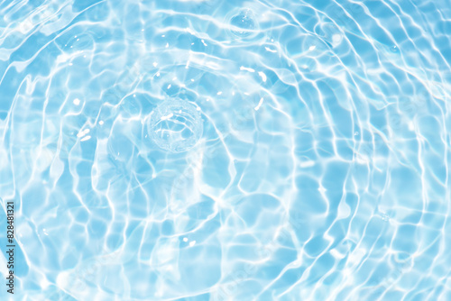 Blue water with ripples on the surface. Defocus blurred transparent blue colored clear calm water surface texture with splashes and bubbles. Water waves with shining pattern texture background. © Water 💧 Shining 📸