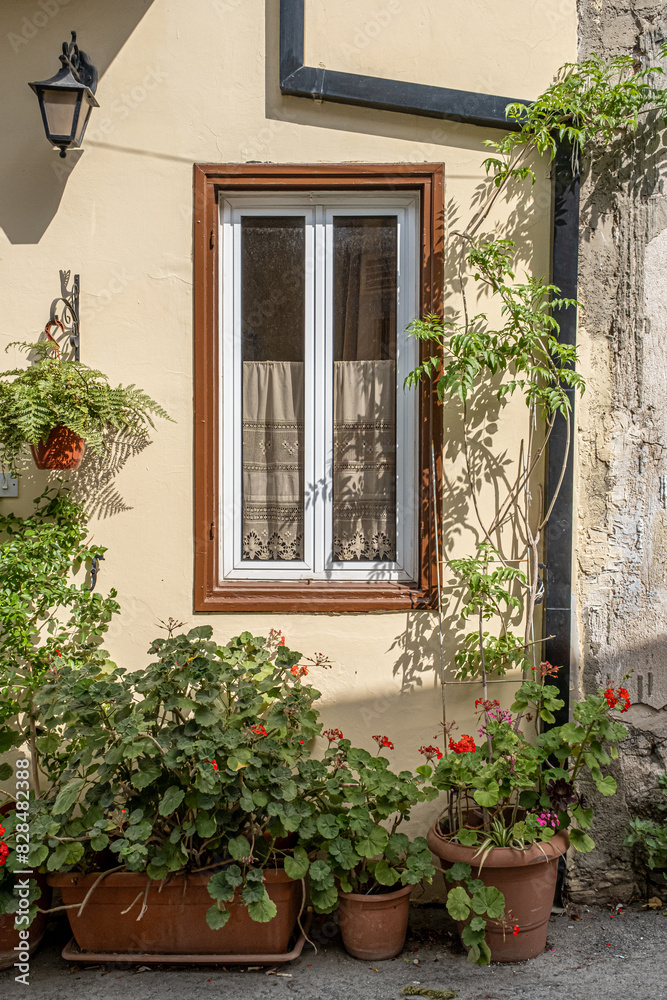 Pano Lefkara village, Larnaka region, Cyprus-May 24, 2024: Stone houses, white walls, narrow cobbled lanes, doors, windows, flowers, flowerpots, billboards, as seen in the village narrow streets 