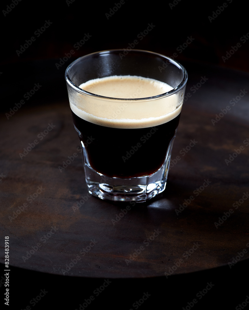 Coffee in glass cup on dark background. Close up. Copy space Coffee in glass cup on dark background. Close up. Copy space