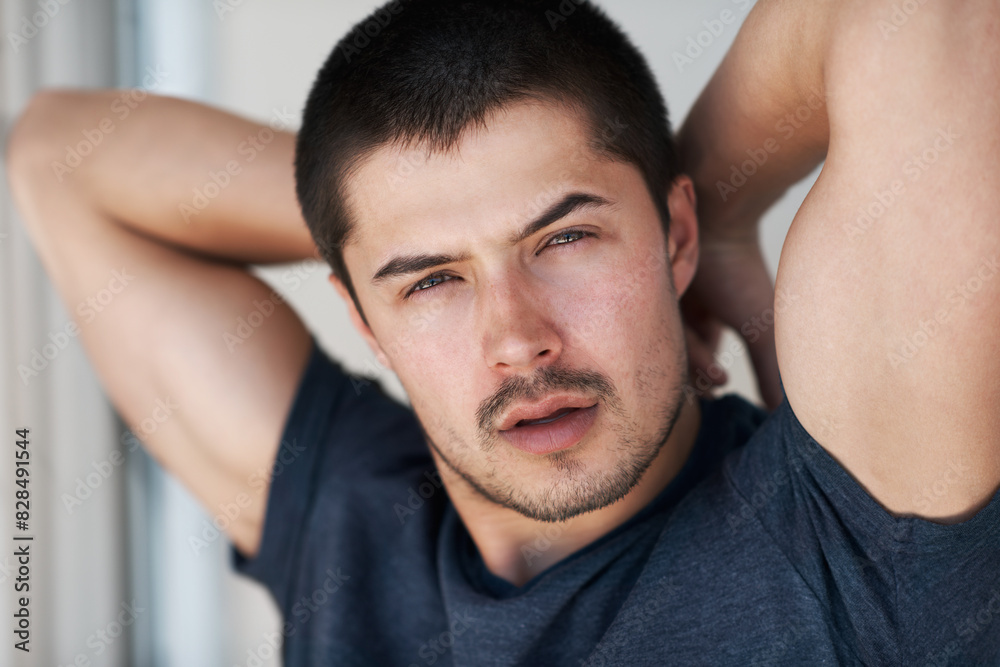 Confidence, fashion and portrait of a man in home for relaxing, chill and pride in apartment. Sexy, flirting and face closeup of person with confident attitude, attractive and handsome in house