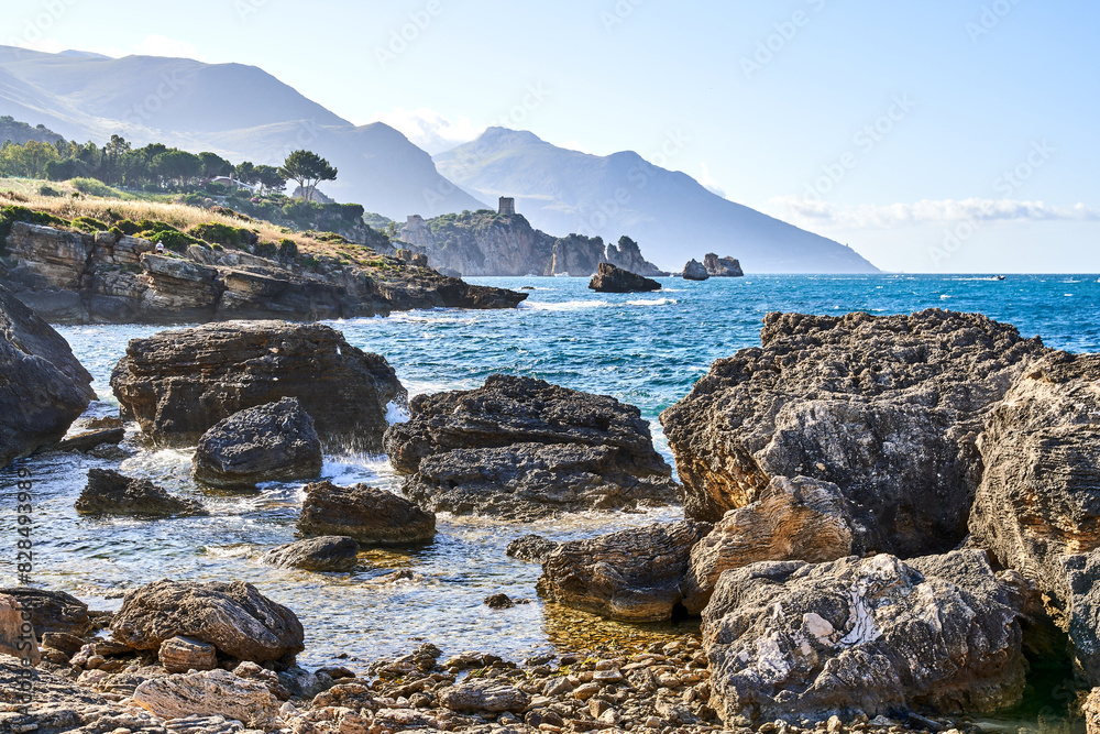 Rocky shore in Sicily surrounded by mountains Rocky shore in Sicily surrounded by mountains