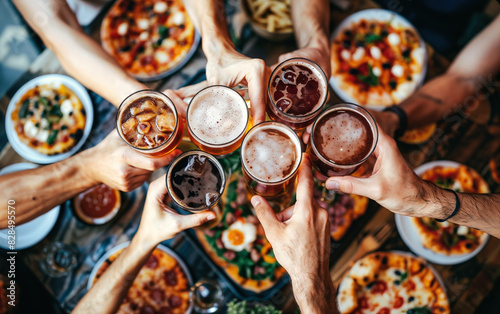 Friends toasting with beer over pizza meal