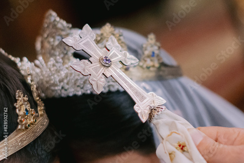 Closeup shot of a silver cross during a traditional Armenian wedding ceremony