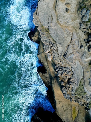 Wallpaper Mural people are surfing in the ocean near some rocks and boulders Torontodigital.ca