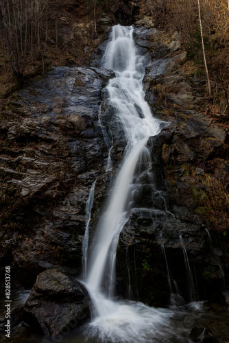 Mountain waterfall meandering amid trees and rocks