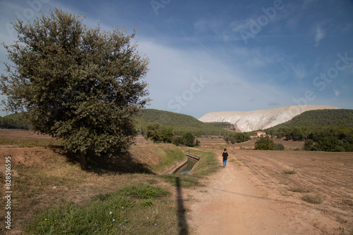 Winding dirt path through a dry grass field in Catalonia © Wirestock
