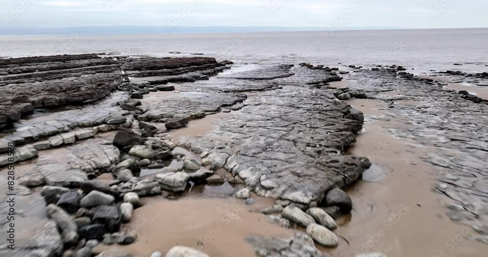 Shot of a rocky coast with the sea visible on a cloudy day. Shot of a rocky coast with the sea visible on a cloudy day.