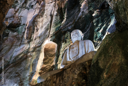 Buddha statue in Llinh Nham Cave Buddhist temple. Marble Mountains, Da Nang, Vietnam.