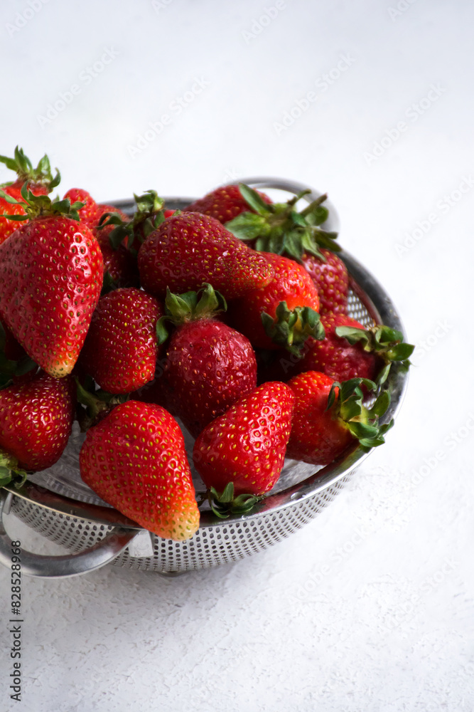 Close-up of a metal colander filled with ripe strawberries Close-up of a metal colander filled with ripe strawberries