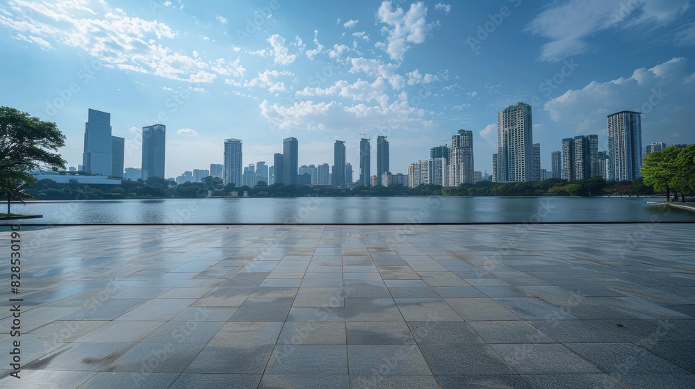 Empty cement floor with lake garden and modern city skyline in background. 