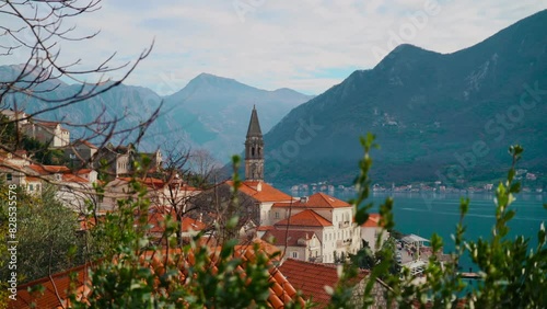 scenery of the church of saint Nicholas in front of the magnificent mountains of Perast, Montenegro