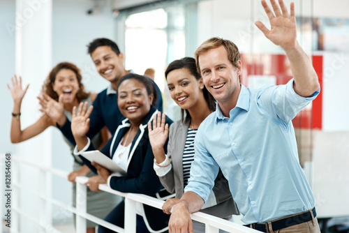 Happy, business people and hand waving to new employee for hello, support and recruitment on office balcony. Smile, corporate group and team with welcome greeting for onboarding and collaboration © peopleimages.com