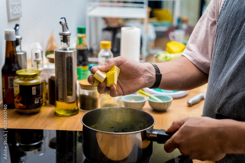 Chef at the kitchen preparing green curry with herbs and rice Chef at the kitchen preparing green curry with herbs and rice