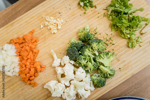 Cutting board with ingredients for preparing lentils soup with cauliflower and broccoli