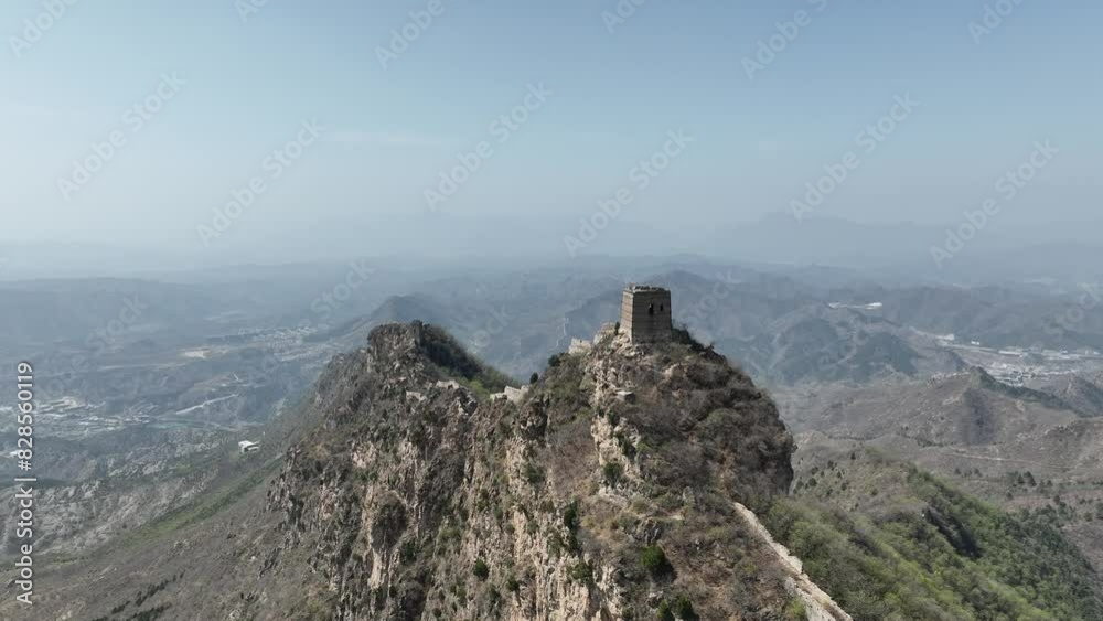 Drone shot of a hill with one of the watchtowers of the Great Wall. Drone shot of a hill with one of the watchtowers of the Great Wall.