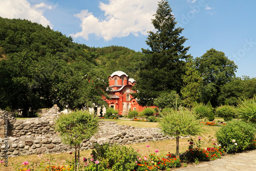 Inside the courtyard, garden of the Patriarchate of Pec Monastery, view between the trees onto the Church Complex, outside Peja, Kosovo photo