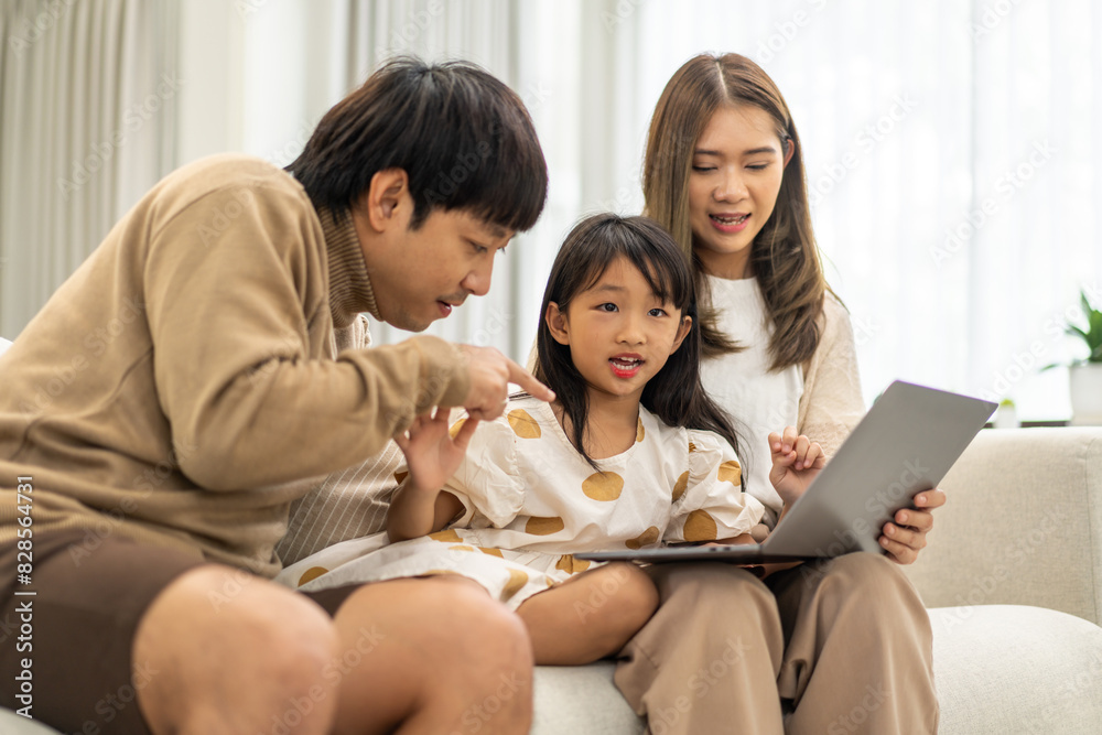 Father and mother with asian kid girl learn on laptop computer reviewing lesson study with online education e-learning.student look for educational knowledge in homeschool at home.Education Father and mother with asian kid girl learn on laptop computer reviewing lesson study with online education e-learning.student look for educational knowledge in homeschool at home.Education