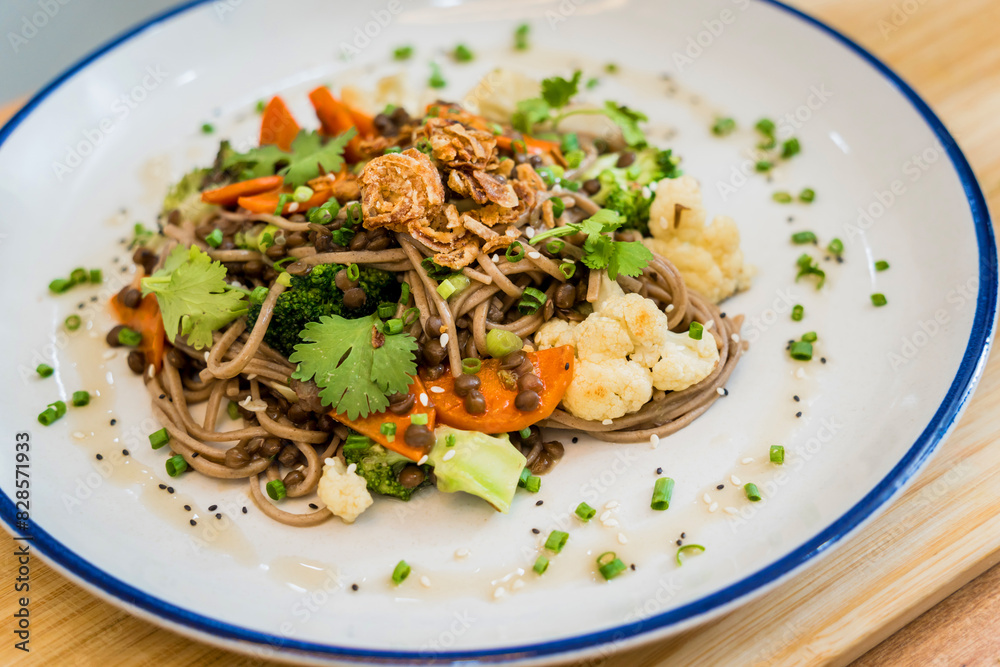 Japanese buckwheat pasta with lentils and vegetables in a bowl Japanese buckwheat pasta with lentils and vegetables in a bowl