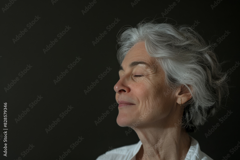 A close up of a woman's face with her eyes closed looking to a side