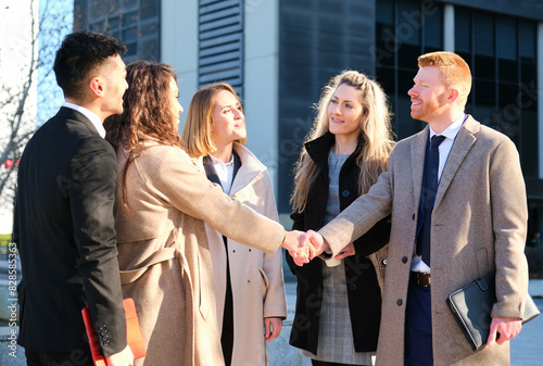 Group of business people closing a deal with international investor client, businessman handshake with businesswoman, standing in the business buildings aera. photo