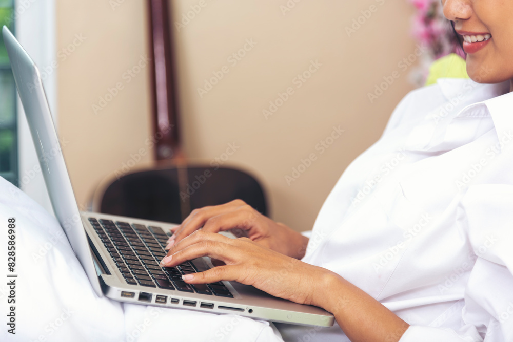 Woman typing laptop computer online meeting at home office work from home. Asian business woman using notebook laptop lifestyle. Happy programmer woman typing keyboard laptop read online website Woman typing laptop computer online meeting at home office work from home. Asian business woman using notebook laptop lifestyle. Happy programmer woman typing keyboard laptop read online website