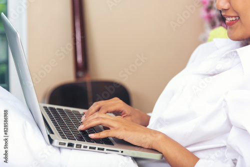 Woman typing laptop computer online meeting at home office work from home. Asian business woman using notebook laptop lifestyle. Happy programmer woman typing keyboard laptop read online website