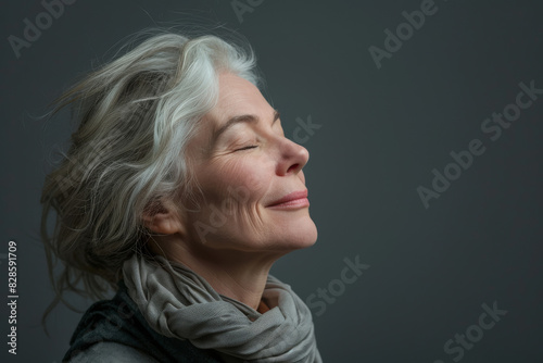 A close up of a woman's face with her eyes closed looking to a side