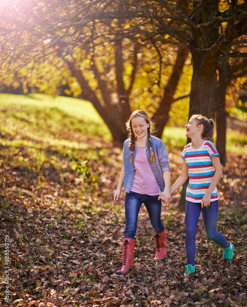 Fototapeta premium Holding hands, happy and children friends in nature walking on adventure together in Autumn. Smile, fun and girl kids exploring in outdoor park, field or garden for bonding on weekend trip in Canada.