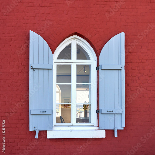 View through a closeup of a window with open blue shutters of the interior of Fisgard Lighthouse. photo