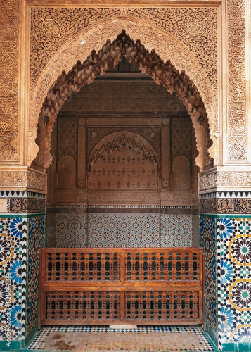 Photography typoical Moroccan architecture with Zeliij mosaics and carved cedarwood arch in