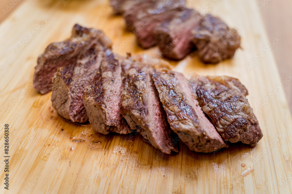 Chef at the kitchen preparing beef steaks on the home electric grill Chef at the kitchen preparing beef steaks on the home electric grill