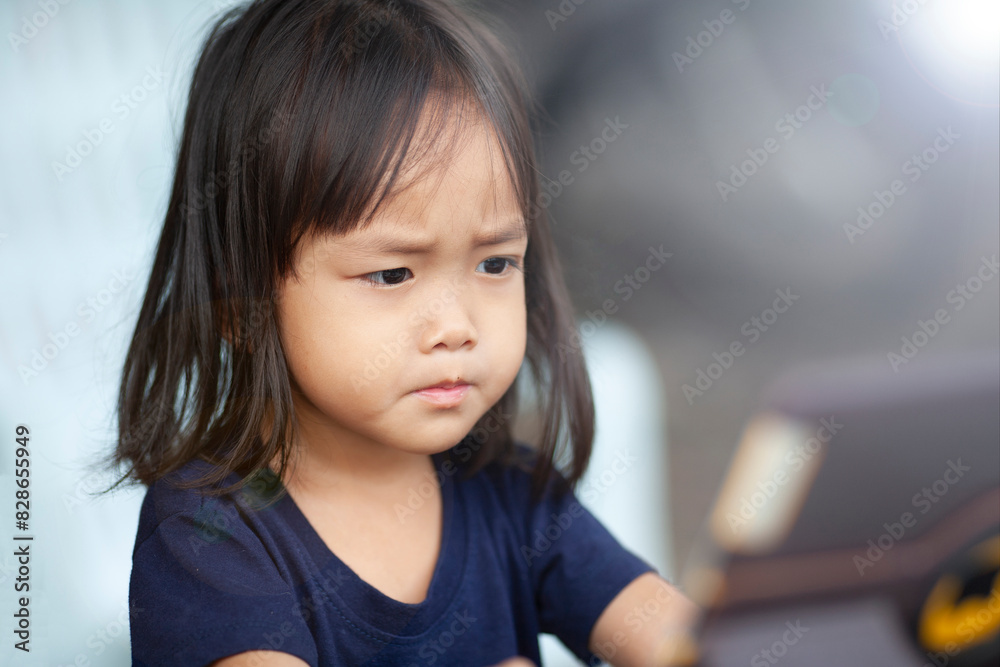 Cute Asian sibling girl sitting Uses the tablet Cute Asian sibling girl sitting Uses the tablet