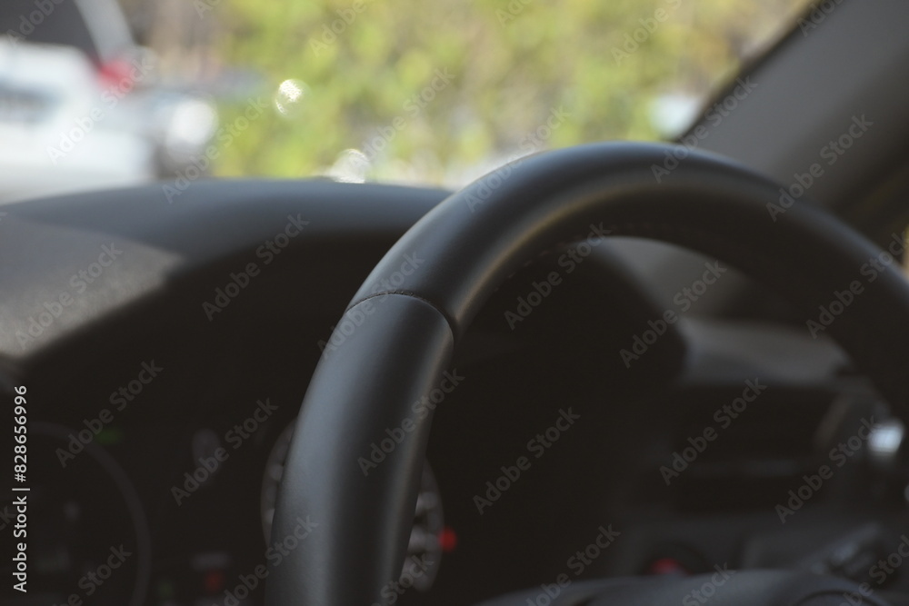 interior view of car with black leather, steering wheel with button