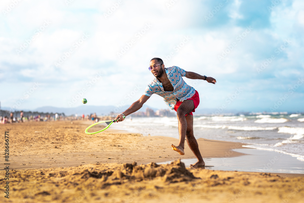 Young Black Boy Enjoying a Sunny Day at the Beach: Engaging in Sports Activities like Volleyball, Soccer, and Beach Tennis Young Black Boy Enjoying a Sunny Day at the Beach: Engaging in Sports Activities like Volleyball, Soccer, and Beach Tennis