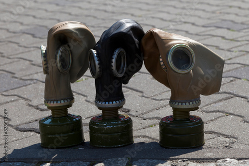 Three soviet gas masks on the pavement © BreizhAtao