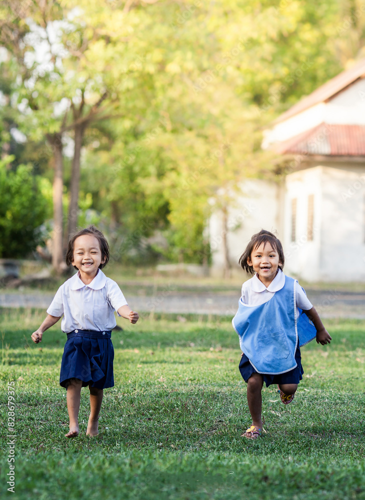 Fototapeta premium Asian little girls run playing on playground