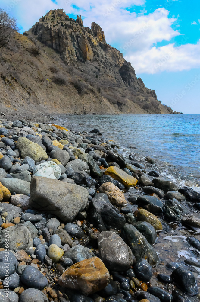 Kara-Dag, volcanic rocks near the Black Sea coast in the national park, rounded pebbles on the beach, Crimea Kara-Dag, volcanic rocks near the Black Sea coast in the national park, rounded pebbles on the beach, Crimea