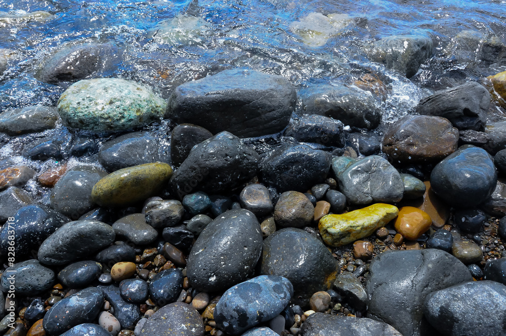 Kara-Dag, a round sea-rolled pebble from a volcanic rock on a pebble beach, Crimea Kara-Dag, a round sea-rolled pebble from a volcanic rock on a pebble beach, Crimea
