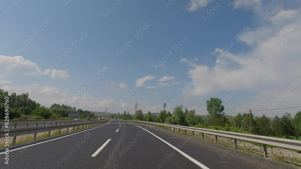 Road view on a summer day. Highways and landscape, palm trees and mountains, roadside and white road line markings. Road view on a summer day. Highways and landscape, palm trees and mountains, roadside and white road line markings.