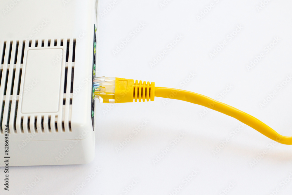 ADSL modem with yellow cable on white surface with copy space ADSL modem with yellow cable on white surface with copy space