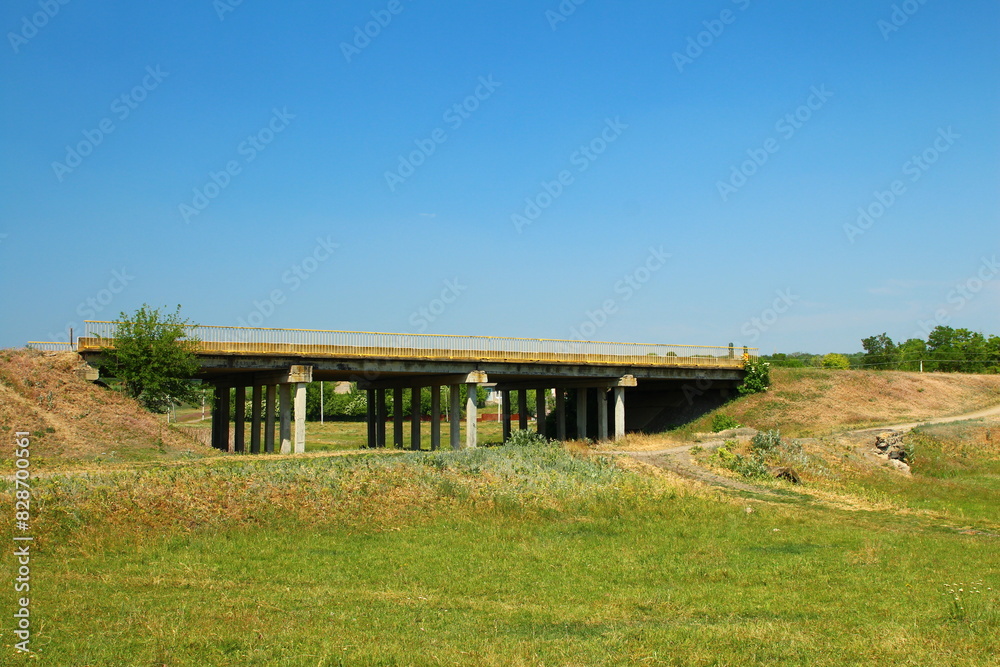 A bridge over a grassy field A bridge over a grassy field