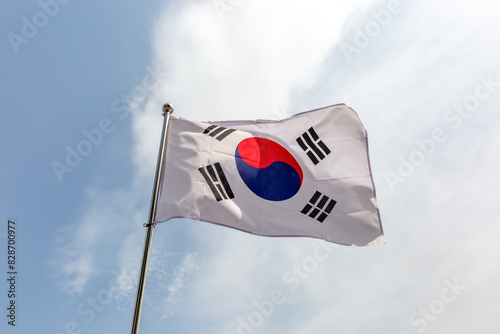 Flag on taegeukgi, Korea flag pole and blue sky, Flag of Korea fluttering in blue sky big national symbol. Waving red blue and white black symbol Korea flag, Independence Constitution Day.
