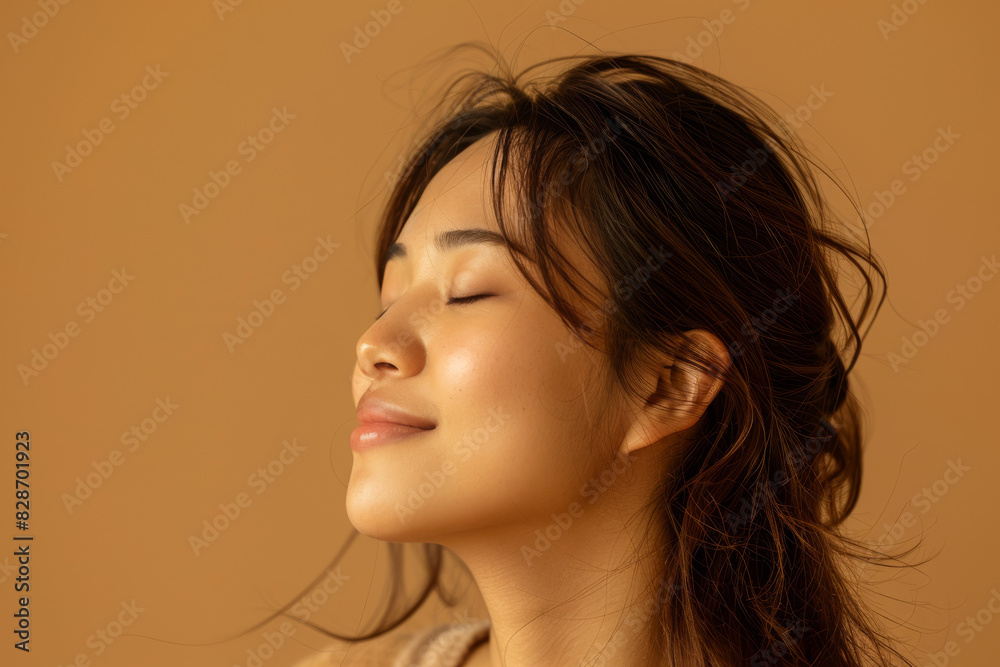 A close up of a woman's face with her eyes closed looking to a side A close up of a woman's face with her eyes closed looking to a side