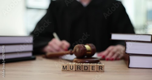 World murder and judge writes verdict in courtroom. Contracted political assassination photo