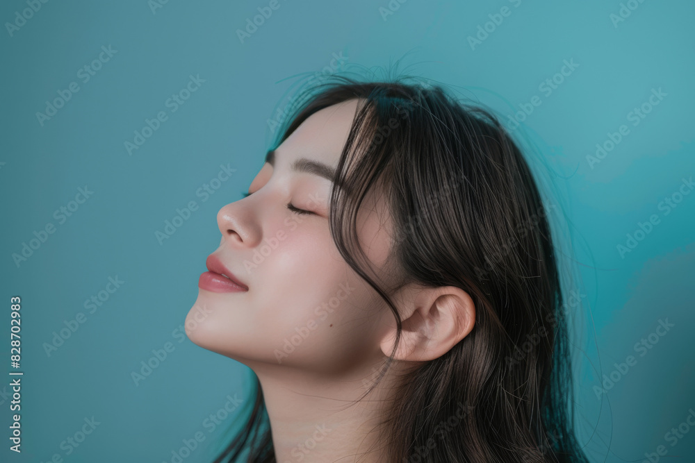 A close up of a woman's face with her eyes closed looking to a side