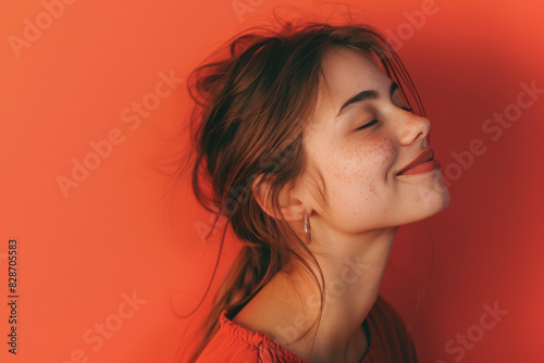 A close up of a woman's face with her eyes closed looking to a side